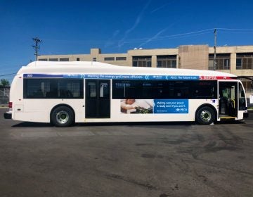 A SEPTA bus is parked in a parking lot, with a blue sky overhead.