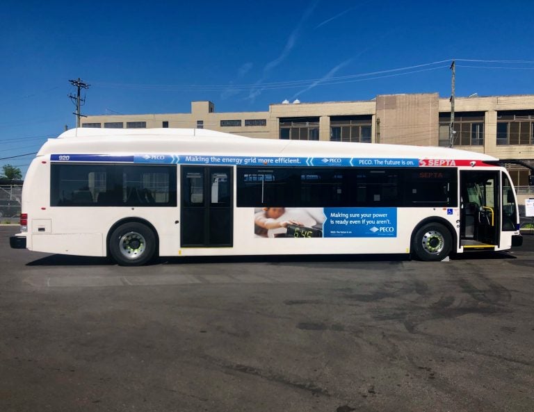 A SEPTA bus is parked in a parking lot, with a blue sky overhead.