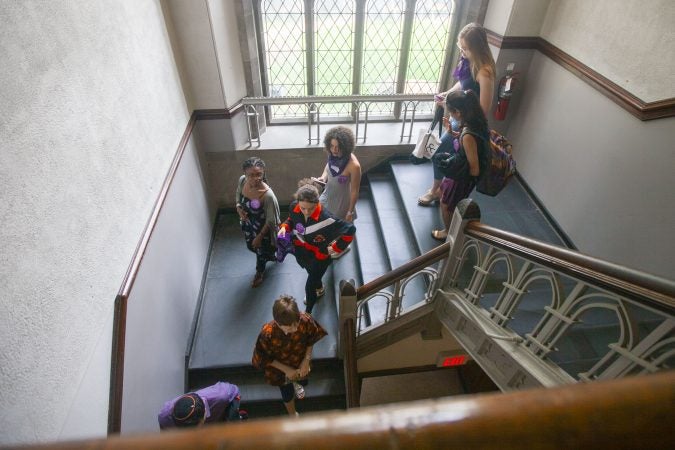 A group of people join Kellen Heniford to protest the presence of Washington, D.C. attorney Beth Wilkinson on a #MeToo panel at Princeton University on June 1, 2019 in Princeton, New Jersey. (Miguel Martinez for WHYY)