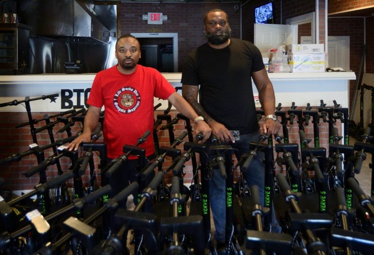 CEO Kevin Thompson and COO Naim Statham present their fleet of close to a hundred Verve E-scooters, stored at a former hamburger take-out restaurant located at the corner of Roosevelt Blvd and F Street, on June 15, 2019. (Bastiaan Slabbers for WHYY)