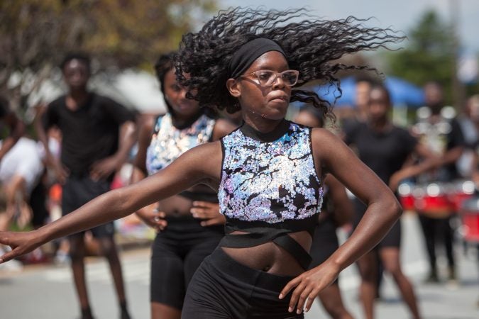 Africa Gary, 18, of the Marching Cobras dances with her team during the annual Marple Newtown Fourth of July parade. (Emily Cohen for WHYY)