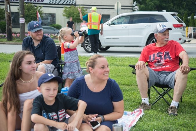 The Pickering Family have been coming to this spot along the parade route since the 1970s. They don’t mind that their spot is now in the quiet zone. They don’t miss the loud sirens, but do miss the band music. (Emily Cohen for WHYY)