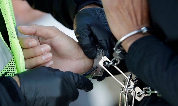 In this Nov. 16, 2018 file photo, an immigrant who entered the United States illegally is checked before boarding a deportation flight to El Salvador by U.S. Immigration and Customs Enforcement in Houston. (David J. Phillip/AP Photo, File)