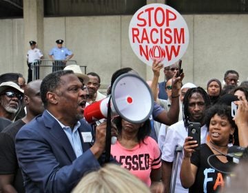 About 200 protesters gather at Philadelphia police headquarters to call for action against police officers who posted racist comments on Facebook. (Emma Lee/WHYY)