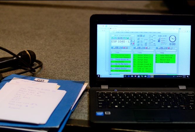 Paper notes lay next to a laptop used by Marilyn 'Zip' Warmerdam to call a 'tip'  at a Center City hotel ballroom during the 36th annual LGBT Square Dance Convention. (Bastiaan Slabbers for WHYY)