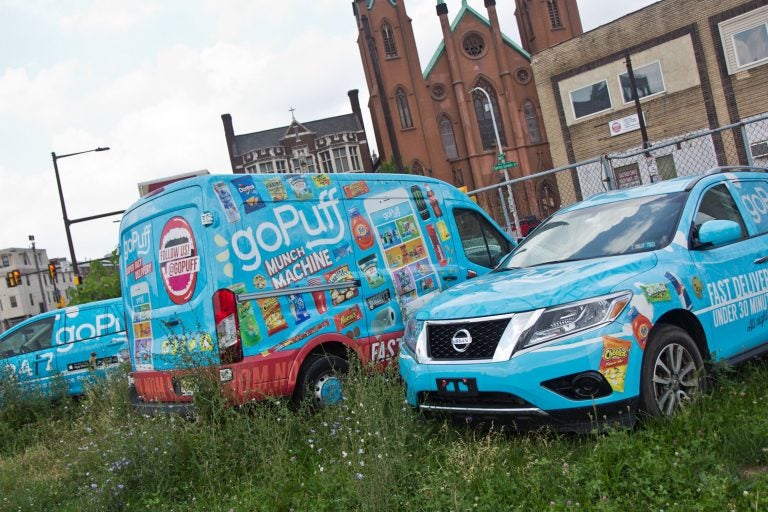 A small fleet of GoPuff delivery vehicles, parked outside their Philadelphia headquarters. (Kimberly Paynter/WHYY)