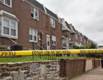 Police officers stand on the 4600 block of Weymouth Street Monday, where a Philadelphia police officer is believed to have killed his wife and then himself. (Kimberly Paynter/WHYY)