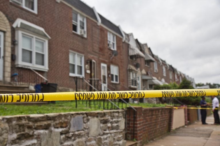 Police officers stand on the 4600 block of Weymouth Street Monday, where a Philadelphia police officer is believed to have killed his wife and then himself. (Kimberly Paynter/WHYY)