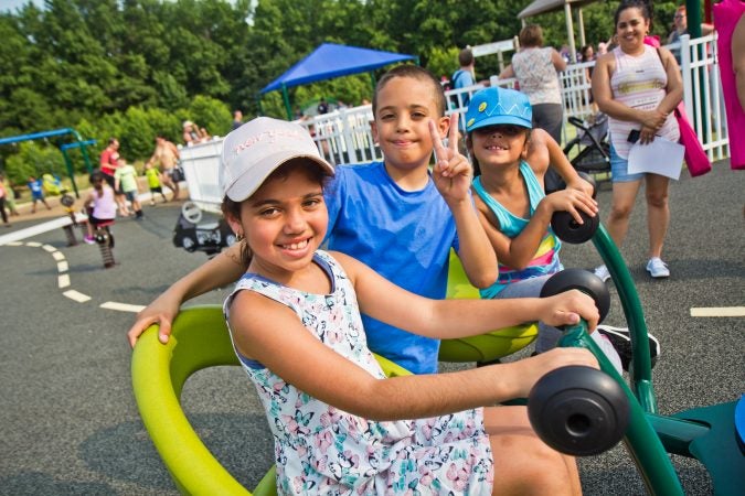 Children play on the four-person sea saw at Delran’s Jake’s Place. (Kimberly Paynter/WHYY)