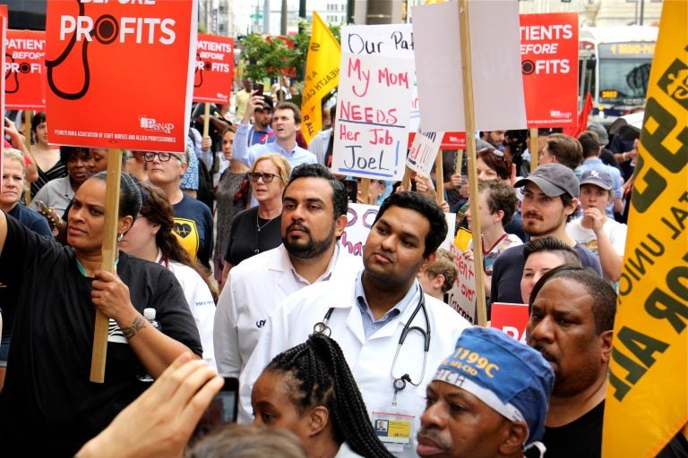 About 800 protesters gather outside Hahnemann Hospital, demanding that the facility remain open and closing the south bound lanes of North Broad Street. (Emma Lee/WHYY)