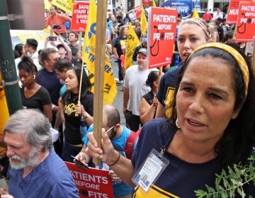 Hahnemann nurse Joelle Leone (right) chants with about 800 protesters outside Hahnemann Hospital to demand that the facility remain open. (Emma Lee/WHYY)