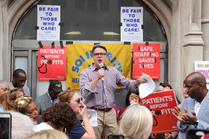 City Council member Bobby Henon speaks at a rally of nurses, doctors, activists and union members seeking to keep Hahnemann Hospital open. (Emma Lee/WHYY)