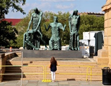 A museum patron pauses at the west entrance of the Philadelphia Museum of Art to look at 