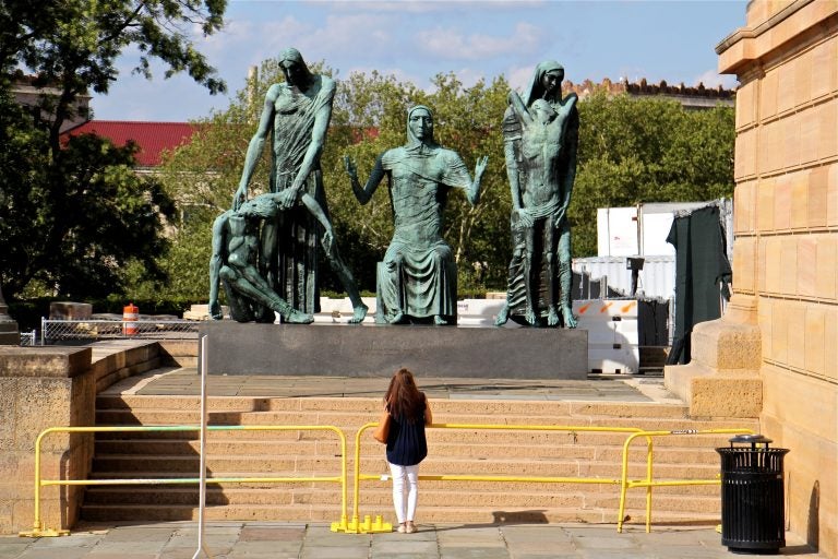 A museum patron pauses at the west entrance of the Philadelphia Museum of Art to look at 