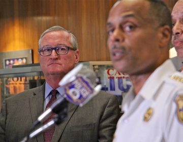 Mayor Jim Kenney listens as Philadelphia Police Commissioner Richard Ross answers reporters questions about an investigation into racist Facebook posts by active duty police officers. (Emma Lee/WHYY)