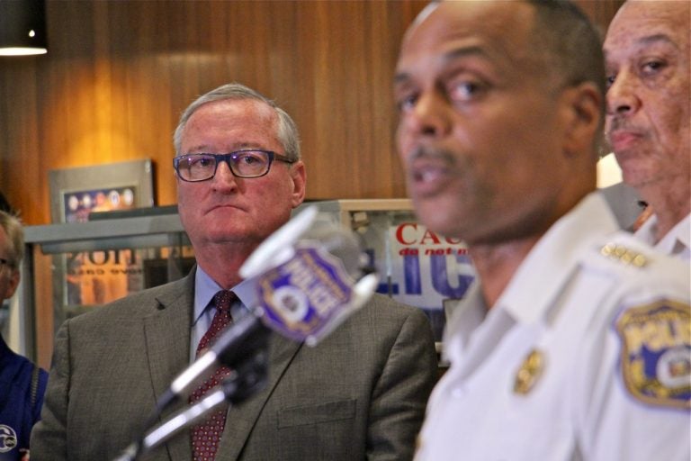 Mayor Jim Kenney listens as Philadelphia Police Commissioner Richard Ross answers reporters questions about an investigation into racist Facebook posts by active duty police officers. (Emma Lee/WHYY)