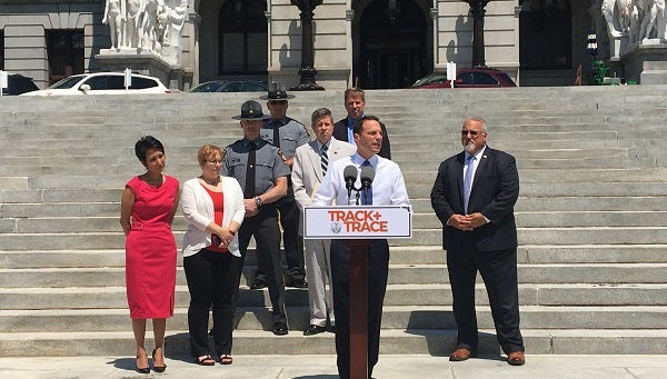 Shapiro and supporters of his Track and Trace initiative on the state Capitol steps Thursday. (Katie Meyer/WITF)