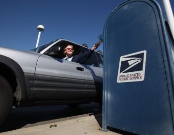 In this photo taken Feb. 24, 2012, mail is deposited into an outdoor postal box (Rich Pedroncelli/AP Photo)
