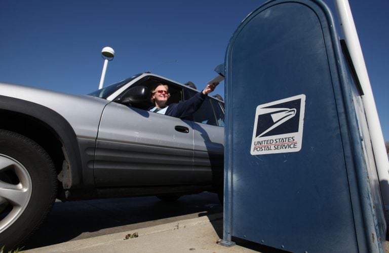 In this photo taken Feb. 24, 2012, mail is deposited into an outdoor postal box (Rich Pedroncelli/AP Photo)