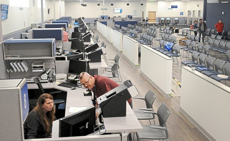 In this Wednesday, Feb. 27, 2019 photo, Acting supervisor Lisa Reeder, left, and supervisor Kevin Keylor of PennDOT Driver's License/Real ID Center run a system test on computers in Bridgeville, Pennsylvania. (Lake Fong/Pittsburgh Post-Gazette via AP)