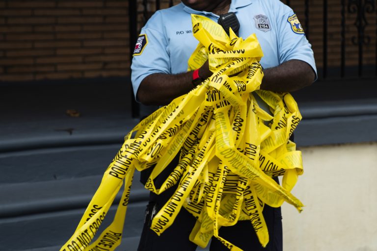 An officer removes crime scene tape after the investigation of what police say was a shooting with one victim in Philadelphia, Wednesday, June 19, 2019. (Matt Rourke/AP Photo)