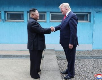 In this Sunday, June 30, 2019, photo provided by the North Korean government, North Korean leader Kim Jong Un, left, and U.S. President Donald Trump shake hands over the military demarcation line at the border village of Panmunjom in Demilitarized Zone. The content of this image is as provided and cannot be independently verified. Korean language watermark on image as provided by source reads: 