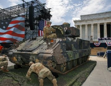 An Army soldier hops out of a Bradley Fighting Vehicle after moving it into place by the Lincoln Memorial, Wednesday, July 3, 2019, in Washington, ahead of planned Fourth of July festivities with President Donald Trump. (Jacquelyn Martin/AP Photo)