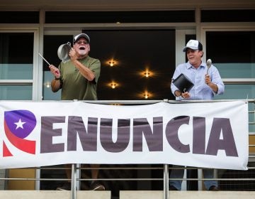 Demonstrators bang on pots, from the balcony of their apartment as they protest against governor Ricardo Rossello, in San Juan, Puerto Rico, Friday, July 19, 2019. (Dennis M. Rivera Pichardoi/AP Photo)