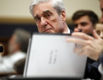 Former special counsel Robert Mueller, checks pages in the report as he testifies before the House Judiciary Committee hearing on his report on Russian election interference, on Capitol Hill, Wednesday, July 24, 2019 in Washington. (Alex Brandon/AP Photo)