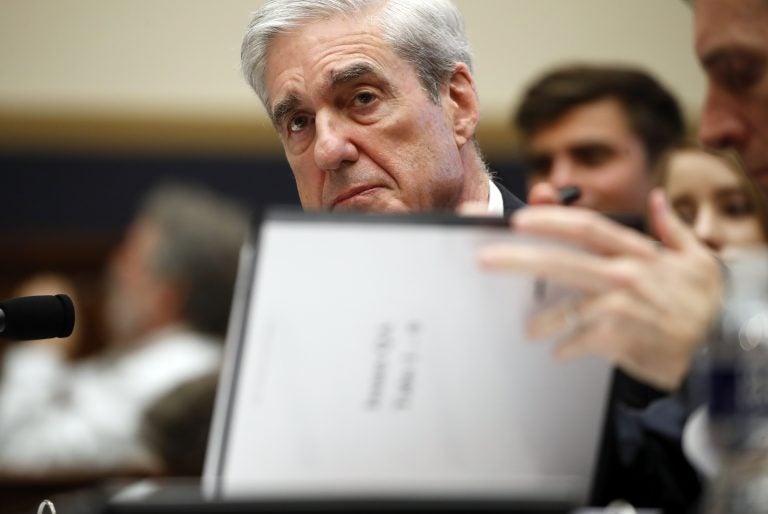 Former special counsel Robert Mueller, checks pages in the report as he testifies before the House Judiciary Committee hearing on his report on Russian election interference, on Capitol Hill, Wednesday, July 24, 2019 in Washington. (Alex Brandon/AP Photo)