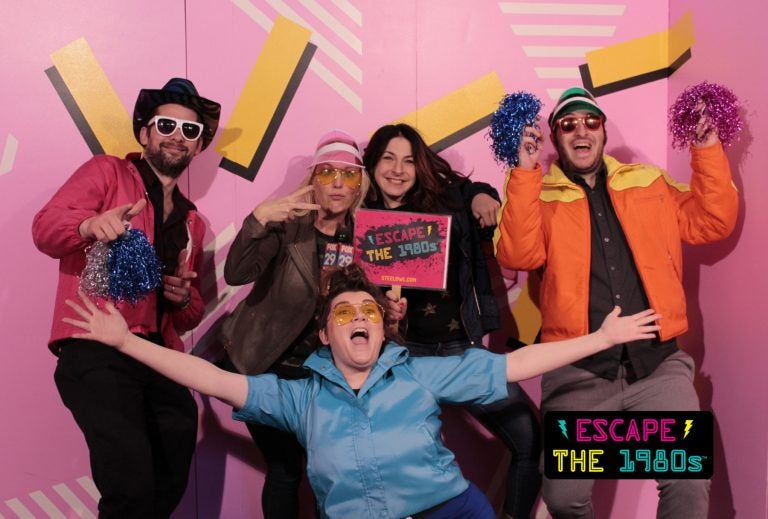 Employees at Escape the 1980s (from left to right): John Foster, Jennaphr Frederick, Elisabeth Garson, Nick Einstman, and Krystle Ann Griffin in the game room's photo booth.  (Image courtesy of Escape the 1980s)