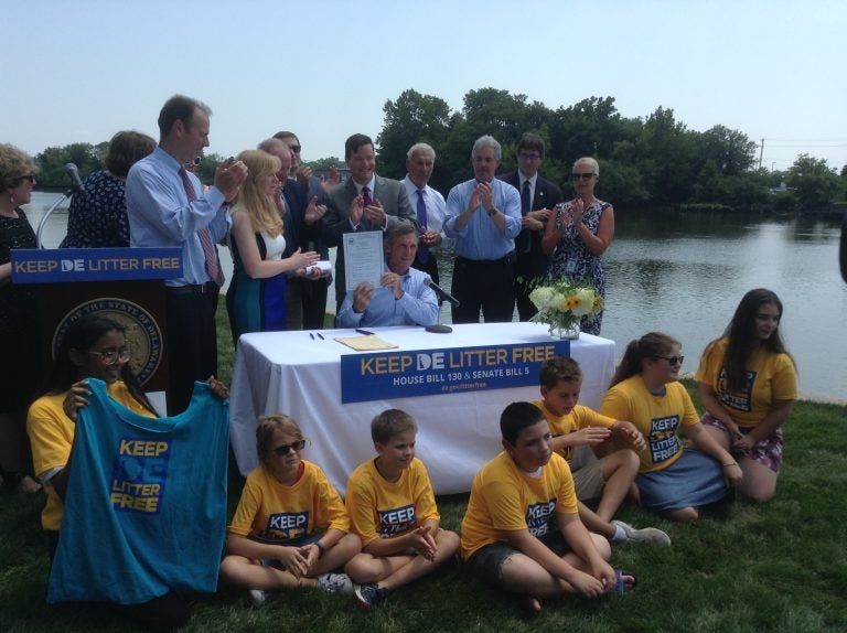 Delaware Governor John Carney signs into law a partial plastic bag ban (Zoë Read/WHYY)