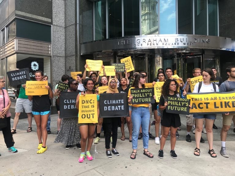 Protesters gather attention outside the building that formerly housed offices of the Pa. Democratic Party. (Naomi Brauner/WHYY)