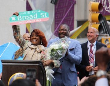 Patti LaBelle holds up a sign named by a portion of Broad Street after her. (Emma Lee/WHYY)