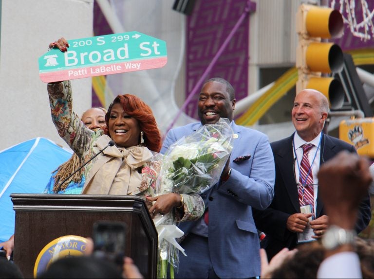 Patti LaBelle holds up a sign named by a portion of Broad Street after her. (Emma Lee/WHYY)