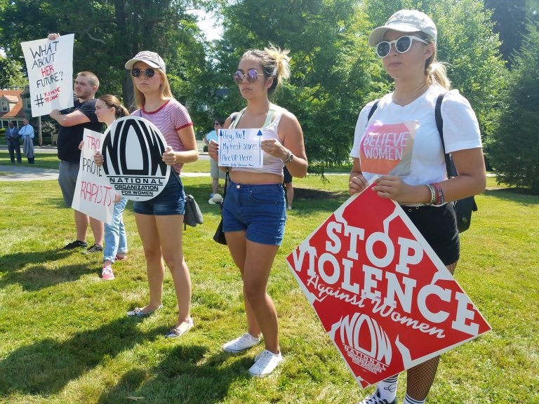 (From left) Friends Olivia Corveleyn, Sienna Bucu and Abby Hagen, all of Union, at a protest in Freehold to demand the removal of Judges Troiano and Silva on July 11, 2019. (Nicholas Pugliese/WHYY)