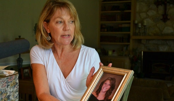Martha Stringer holds a photo of her daughter, Kim, from when she was in high school. Kim is 27 now. (Brett Sholtis/WITF)