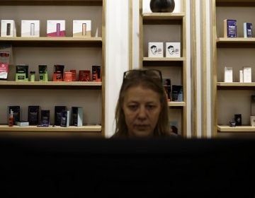 Salesperson Cheri McFarland works on a sales computer in front of displayed marijuana products at Beyond/Hello, Center City Philadelphia's first medical marijuana dispensary on Jan. 24, 2019. (Matt Slocum/AP Photo)