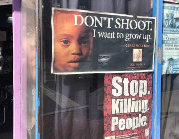 posters on a barbershop window in downtown Wilmington