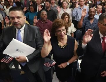 New citizens take the oath of allegiance during a naturalization ceremony in Oakland Park, Fla., earlier this year. The Trump administration has announced there will be changes to the U.S. citizenship test. (Wilfredo Lee/AP Photo)