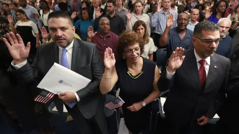 New citizens take the oath of allegiance during a naturalization ceremony in Oakland Park, Fla., earlier this year. The Trump administration has announced there will be changes to the U.S. citizenship test. (Wilfredo Lee/AP Photo)