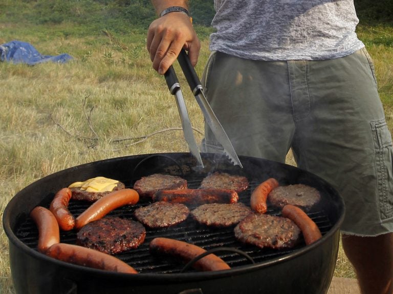 When it comes to Fourth of July barbecue etiquette, Bon Appetit food director Carla Lalli Music says you should avoid hovering if you are a guest. If you want to be helpful, she says, bring some extra ice or non-alcoholic drinks. (Alex Brandon/AP Photo)