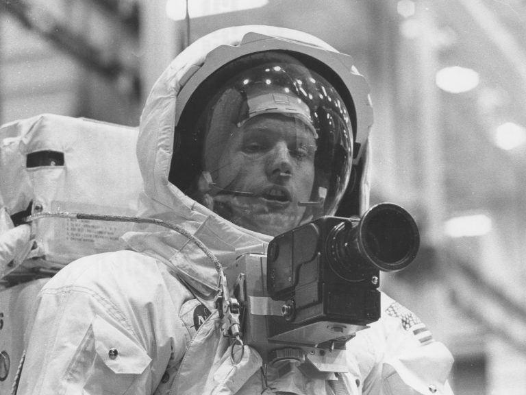 Neil Armstrong tests out his spacesuit and camera in April 1969, three months before he would actually set foot on the moon. (NASA/Project Apollo Archive)