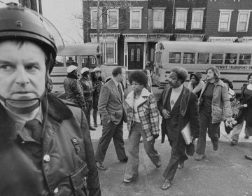 Buses arrive at South Boston High School, Jan. 8, 1975. Police were on hand to provide protection as black students arrived. (AP Photo)