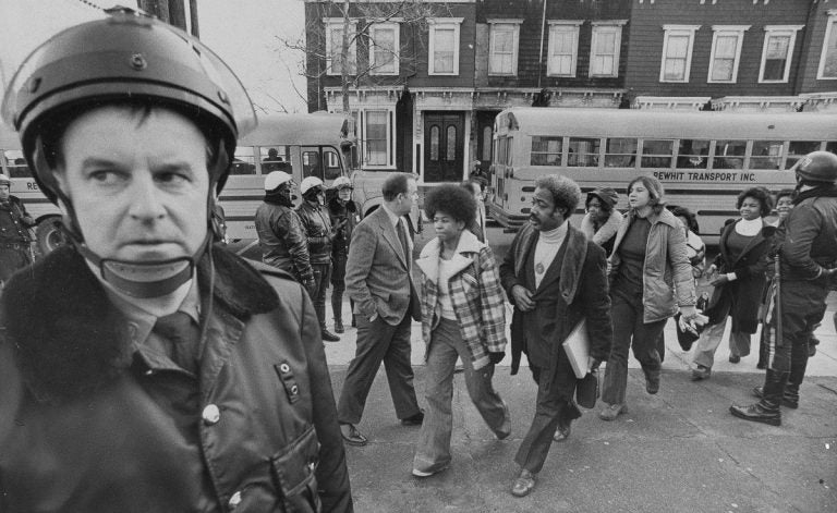 Buses arrive at South Boston High School, Jan. 8, 1975. Police were on hand to provide protection as black students arrived. (AP Photo)