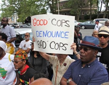 Protesters gather at Philadelphia police headquarters to call for action against police officers who posted racist comments on Facebook. (Emma Lee/WHYY)