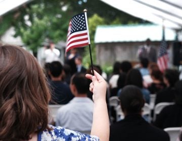 A child holds a U.S. flag at a naturalization ceremony at the Wyckoff House Museum in Brooklyn, on June 14, in New York City. (Spencer Platt/Getty Images)