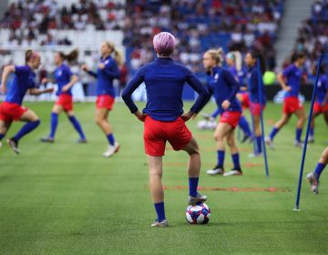 The Netherlands are the last team standing between the United States and its fourth Women's World Cup. Here, U.S. forward Megan Rapinoe watches her teammates warm up before Tuesday's 2-1 semifinal win over England. (Alex Grimm/Getty Images)