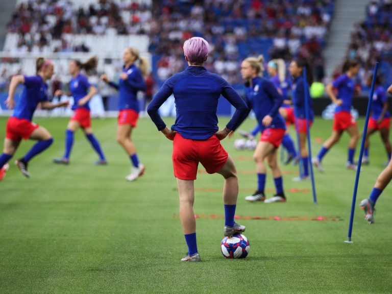 The Netherlands are the last team standing between the United States and its fourth Women's World Cup. Here, U.S. forward Megan Rapinoe watches her teammates warm up before Tuesday's 2-1 semifinal win over England. (Alex Grimm/Getty Images)