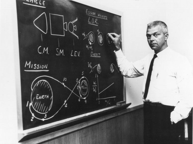 American aerospace engineer John Houbolt as he stands at a chalkboard in July 1962 showing his lunar orbit rendezvous plan for landing astronauts on the moon. (NASA/LARC/Bob Nye/PhotoQuest/Getty Images)